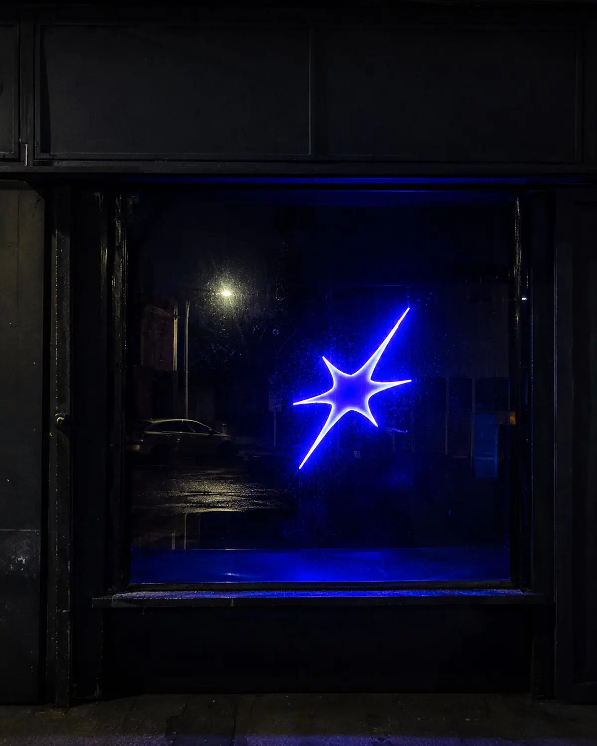 La estrella de ITER encendida en el escaparate de un local, de noche